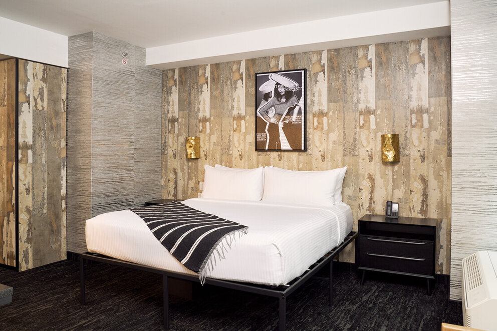 a bed with a black and white blanket