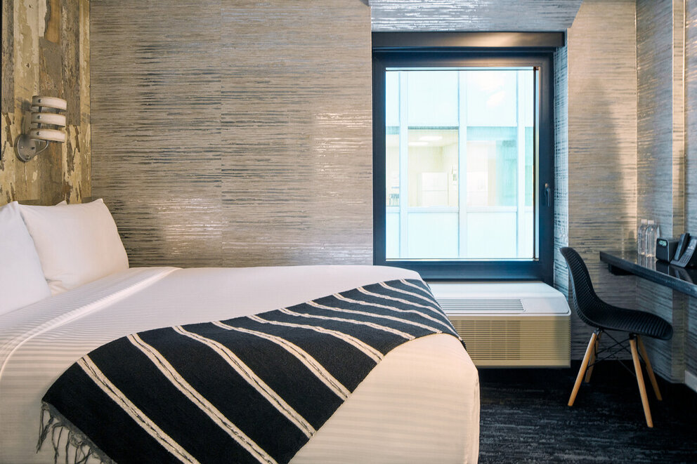 a bed with a striped blanket in a room