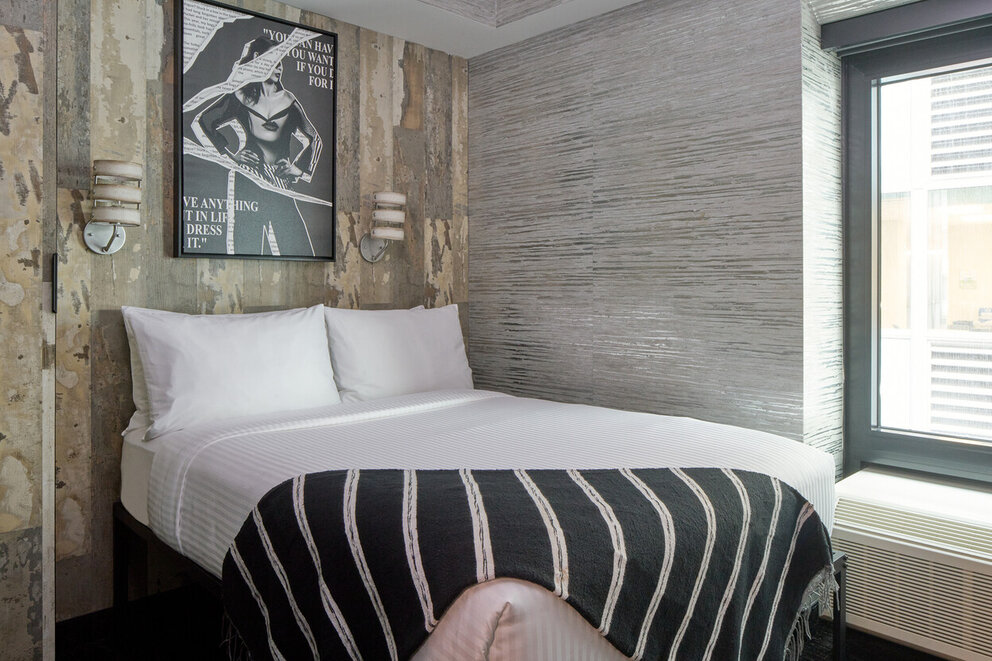 a bed with a striped blanket in a room