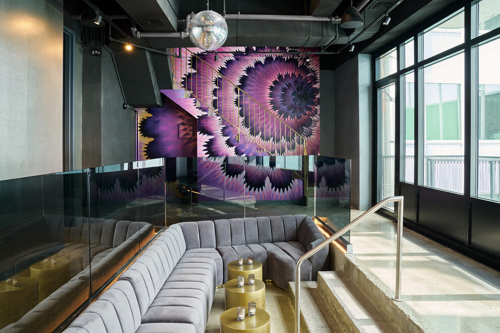 a room with a couch and a wall of stairs