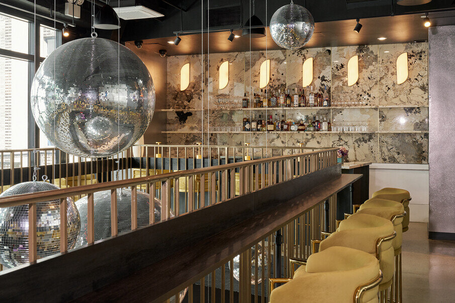 a bar with a mirror ball from the ceiling