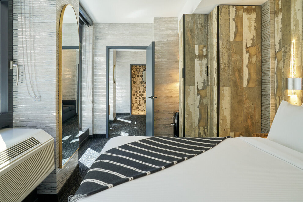 a room with a bed and a mirror