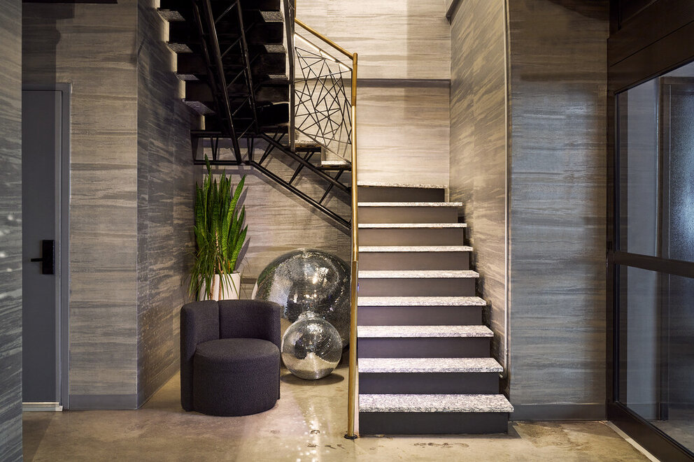 a staircase with a mirror ball and a chair
