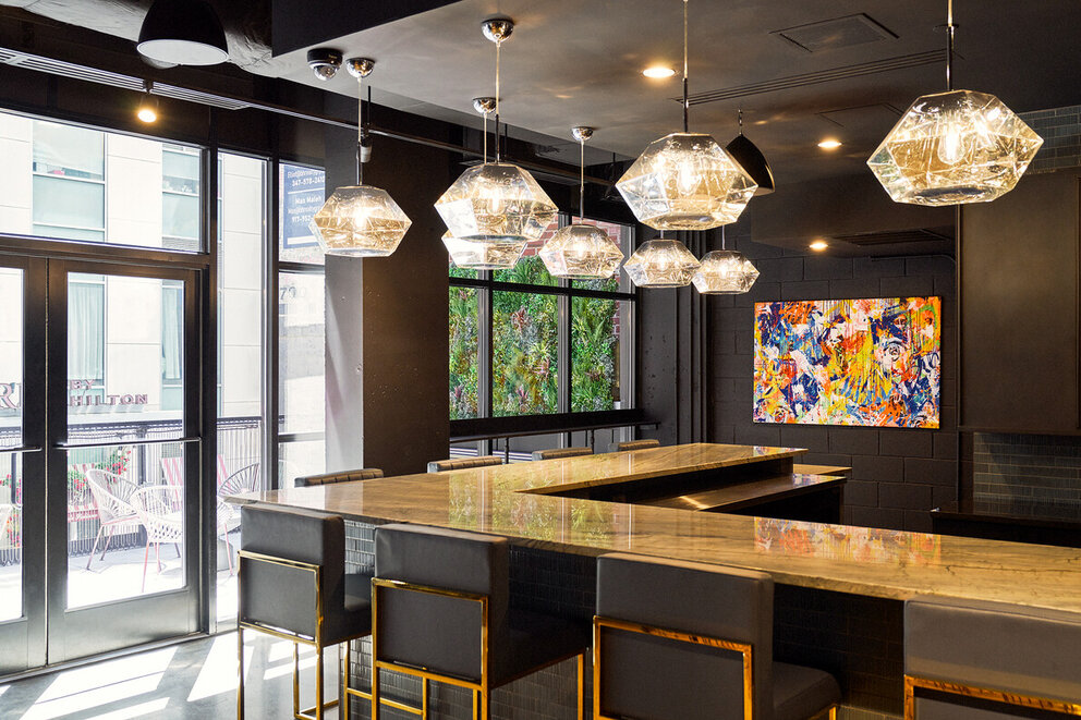 a bar with lights from the ceiling